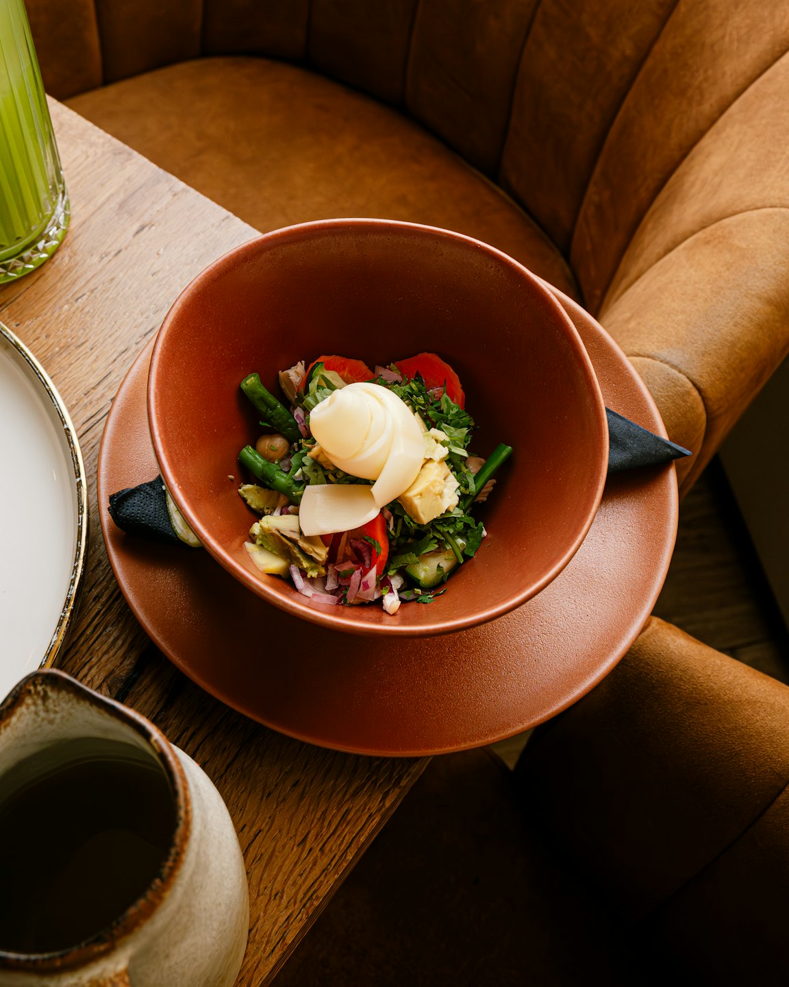 Salad with vegetables and egg in a ceramic bowl.